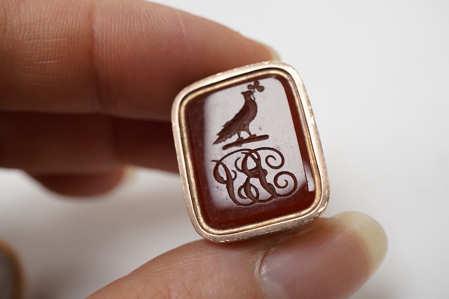 Three assorted 19th century yellow metal over laid fob seals, to include spinning set with three chalcedony stones, oval with white chalcedony carved with initials and rectangular with carnelian varved with a crest, larg